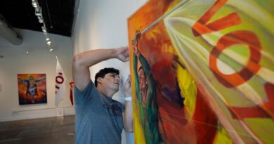 AP PHOTOS: An artist summons Superman to remind people the power of voting